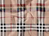 A close-up view of a fabric with a plaid pattern. Produktbild-Vorschau