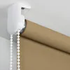 Close-up of a roller blind mechanism and fabric attached to a ceiling. Produktbild-Vorschau
