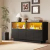 A modern black sideboard with illuminated glass cabinets sits on a beige carpet. Produktbild-Vorschau