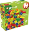 A green box of Hubelino building blocks, with a pile of colorful blocks spilling out. Produktbild-Vorschau