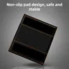 A black tray with orange trim, angled on a gray surface. Produktbild-Vorschau