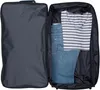 An open suitcase with clothes packed inside. Produktbild-Vorschau