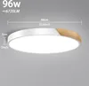 A close-up shot of a modern LED ceiling light with a white finish and a wood accent, displaying its dimensions. Voir les images du produit