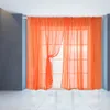 A window with orange sheer curtains. Produktbild-Vorschau