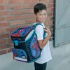 A young boy is wearing a backpack. Produktbild-Vorschau