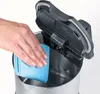 A hand is cleaning the inside of a kettle with a blue cloth. Produktbild-Vorschau