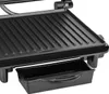 Close-up view of a black electric panini grill, showing the ribbed cooking surface and a removable drip tray underneath. Produktbild-Vorschau