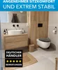 A modern bathroom with a floating vanity, toilet, and wooden accents. Produktbild-Vorschau