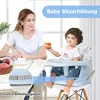 A mother and child are at a table, with the child sitting in a high chair. Podgląd zdjęcia produktu