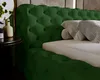 A close-up view of a green tufted bed frame with pillows on the mattress. Náhľad obrázku produktu