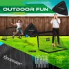 A backyard scene with two soccer goals, a child jumping, and an adult covering their eyes, promoting outdoor fun. Produktbild-Vorschau