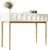 A white vanity table with gold legs and decorative drawer fronts, on a white background. Podgląd zdjęcia produktu