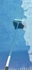 A pool skimmer is being used to clean a tiled swimming pool. Produktbild-Vorschau