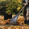 A person raking leaves in a yard with a leaf bag in the background. Náhľad obrázku produktu