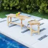 A wooden garden bench sits on a patio next to a swimming pool, with drinks and a blanket on it. Produktbild-Vorschau