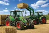 Two green tractors in a field, one lifting a hay bale. Náhled obrázku produktu