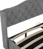A close-up view of a gray upholstered bed frame with a tufted headboard and wooden slats for the mattress. Produktbild-Vorschau