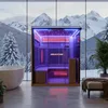 An infrared sauna in a modern bathroom with a large window overlooking a snowy mountain landscape. Produktbild-Vorschau