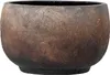A close-up view of a round, textured planter pot with a dark, earthy color palette. Produktbild-Vorschau