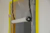 A plastic dust protection door with zippers and a rolled-up section, installed in a doorway. Produktbild-Vorschau