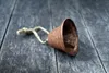 A rusty bell with a rope lies on a wooden surface. Náhľad obrázku produktu