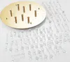 A gold-colored ceiling plate with several gold-colored cylindrical mounts and many strings of clear crystal beads are laid out on a white surface. Produktbild-Vorschau