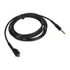 A black audio cable coiled on a white background. Podgląd zdjęcia produktu