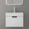 A modern white bathroom vanity with a sink and faucet against a gray wall. Produktbild-Vorschau