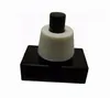 A black and white push button switch on a white background. Náhled obrázku produktu