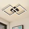 A modern geometric ceiling light fixture with black and white elements, illuminated against a neutral ceiling. Produktbild-Vorschau