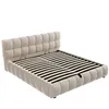 A beige upholstered bed frame with a slatted mattress base, shown from a diagonal angle against a white background. Produktbild-Vorschau