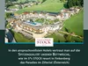 An aerial view of a resort hotel nestled in a green mountainous landscape. Produktbild-Vorschau