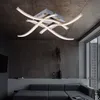 A modern living room with a sectional sofa and a unique ceiling light fixture. Produktbild-Vorschau