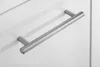 A close-up shot of a silver cabinet handle on a white cabinet door. Produktbild-Vorschau