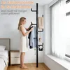 A woman is selecting clothes from a coat rack in a bedroom. Produktbild-Vorschau