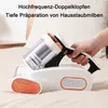 A hand holding a white and copper handheld vacuum cleaner over a beige surface, likely a bed. Produktbild-Vorschau