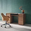 A modern office desk with a chair in front of a green tiled wall. Anteprima dell’immagine prodotto