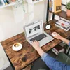 A person is using a laptop on a rustic wooden desk with a coffee cup and a small alarm clock. Produktbild-Vorschau
