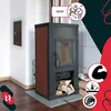 A black wood-burning stove with red side panels, set in a room with white walls and wooden flooring. There are several informational icons and text overlays. Náhľad obrázku produktu