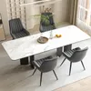 A dining room scene with a marble-top table and four chairs. Voir les images du produit