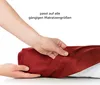Hands are shown adjusting a red fabric product, possibly a mattress topper or protector, against a white background. Náhled obrázku produktu