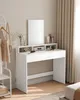 A white dressing table with a mirror and various cosmetics is shown. Náhled obrázku produktu