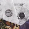 Close-up of two grommets on a white sheer curtain with a floral pattern. Produktbild-Vorschau