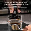 A person's hand is shown using a coffee tamper to level coffee grounds in a portafilter. Náhled obrázku produktu