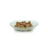 A close-up shot of wet dog food in a clear bowl against a white background. Produktbild-Vorschau