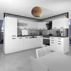 A modern, white L-shaped kitchen unit with black handles, set against a city skyline view through a window. Produktbild-Vorschau