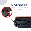 A close-up of a printer toner cartridge with a warning symbol and text. Produktbild-Vorschau