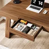 A close-up view of an open desk drawer filled with office supplies and personal items. Anteprima dell’immagine prodotto