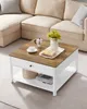 A coffee table with items on it, placed in front of a sectional sofa. Náhled obrázku produktu
