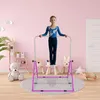 A young girl is using a gymnastics bar in a child's room. Voir les images du produit